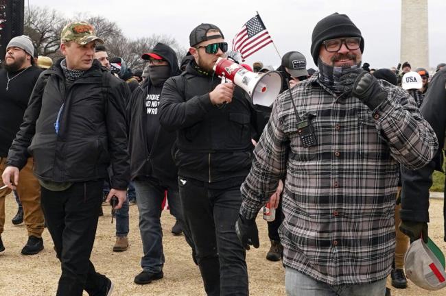 FILE - Proud Boys members including Zachary Rehl, left, Ethan Nordean, center, and Joseph Biggs, walk toward the U.S. Capitol in Washington, in support of President Do<em></em>nald Trump on Jan. 6, 2021. (AP Photo/Carolyn Kaster, fFle)