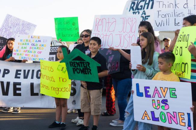 Residents of Little Woods Mobile Villa hold signs during a news co<em></em>nference held in the wake of threats to the mobile park’s closure on August 29, 2023. (Courtesy of Lina Blanco-Ogden/North Bay Organizing Project)