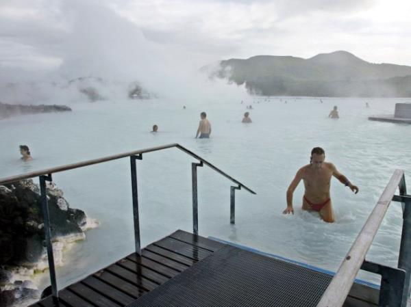 FILE-Bathers enjoy the warm water of the Blue Lagoon on Iceland on Sept.5, 2003. The geothermal spa Blue Lagoon has temporarily closed after a series of earthquakes have put Iceland's southwestern corner on volcanic a<em></em>lert, reaching a state of panic on Thursday when a magnitude 5.0 earthquake occurred just after midnight. (AP Photo/Frank Augstein, File)