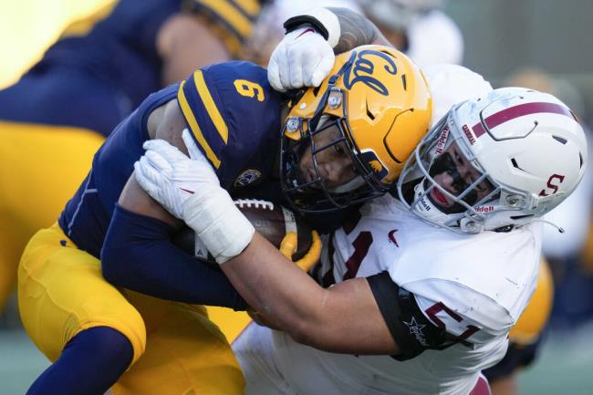 FILE - Stanford defensive lineman Jaxson Moi tackles California running back Jaydn Ott (6) during the first half of an NCAA college football game in Berkeley, Calif., Saturday, Nov. 19, 2022. The Atlantic Coast Co<em></em>nference has cleared the way for Stanford, California and SMU to join the league, two people with direct knowledge of the decision told The Associated Press on Friday, Sept. 1, 2023, providing a landing spot for two more teams from the disintegrating Pac-12.(AP Photo/Godofredo A. Vásquez, File)