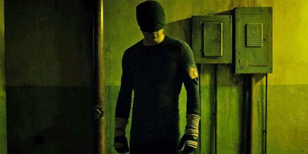 Daredevil Matt Murdoch hiding his face stands in a corridor a<em></em>bout to fight
