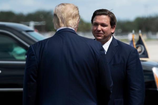 Florida Gov. Ron DeSantis (R) greets then-President Do<em></em>nald Trump in Fort Myers, Florida, in October 2020. DeSantis seemingly aims to argue that he'd be a better president than Trump without attacking him.