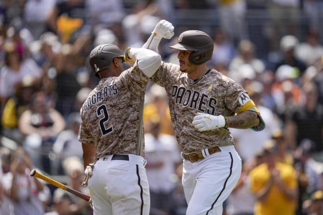 San Diego Padres' Manny Machado, right, celebrates with teammate Xander Bogaerts after hitting a home run during the third inning of a ba<em></em>seball game against the San Francisco Giants, Sunday, Sept. 3, 2023, in San Diego. (AP Photo/Gregory Bull)