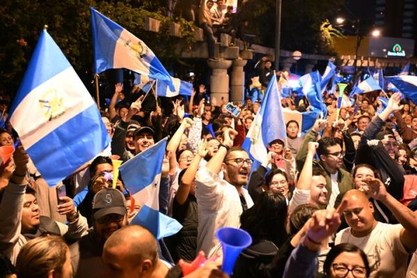 Supporters of Guatemalan presidential candidate for the Semilla party, Bernardo Are<em></em>valo, celebrate the results of the presidential run-off election in Guatemala City, on Aug. 20, 2023. 