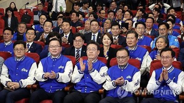 Officials of the main opposition Democratic Party, including it leader Lee Jae-myung (C, front row), clap at the Natio<em></em>nal Assembly in Seoul on April 10, 2024, as TV exit polls of the general elections to choose 300 lawmakers project its landslide victory. (Pool photo) (Yonhap)