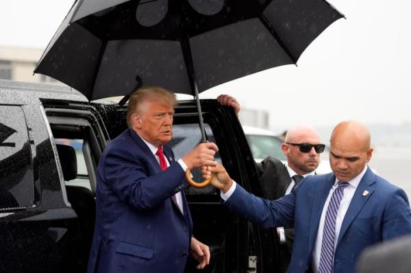 Valet Walt Nauta hands former President Do<em></em>nald Trump an umbrella before he speaks at Ro<em></em>nald Reagan Washington Natio<em></em>nal Airport, Aug. 3, 2023, in Arlington, Va. 