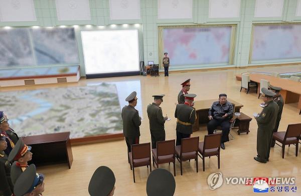 North Korean leader Kim Jong-un (seated) visits the Kim Jong-il University of Military and Politics on April 10, 2024, in this photo released by the Korean Central News Agency the following day. (For Use o<em></em>nly in the Republic of Korea. No Redistribution) (Yonhap)