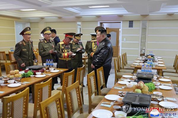 North Korean leader Kim Jong-un (R) visits the Kim Jong-il University of Military and Politics on April 10, 2024, in this photo released by the Korean Central News Agency the following day. (For Use o<em></em>nly in the Republic of Korea. No Redistribution) (Yonhap)