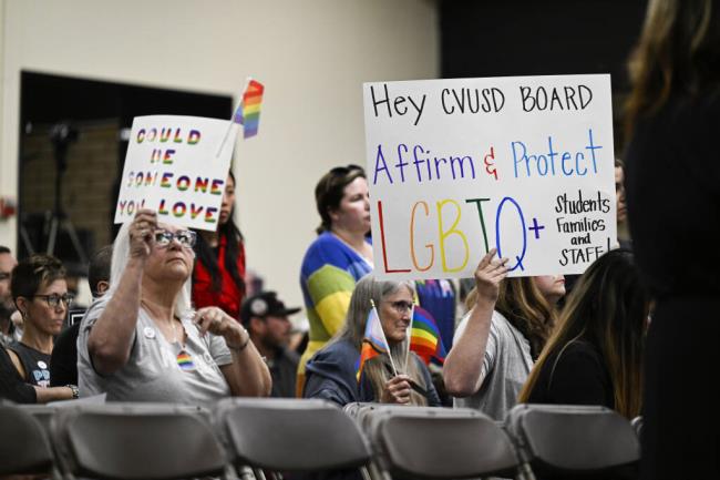 Parents, students, and staff of Chino Valley Unified School District hold up signs in favor of protecting LGBTQ+ policies at Don Anto<em></em>nio Lugo High School, on Thursday, June 15, 2023. California's attorney general has sued a Southern California school district over its new policy that requires schools to notify parents if their children change their gender identification or pronouns. Attorney General Rob Bo<em></em>nta announced the suit Monday, Aug. 28, against Chino Valley Unified School District. (Photo by Anjali Sharif-Paul/The Orange County Register via AP)