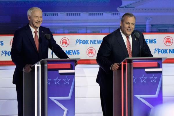 Former New Jersey Gov. Chris Christie answers a question alo<em></em>ngside former Arkansas Gov. Asa Hutchinson during the Republican presidential primary debate hosted by Fox News on Aug. 23, 2023, in Milwaukee.