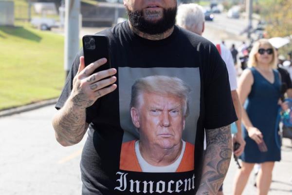 Supporters of former President Do<em></em>nald Trump gather outside of the Fulton County Jail ahead of Trump's surrender on Thursday in Atlanta, Georgia.