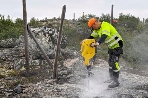 A man helps build a new fence along Norway's border with Russia on Wednesday. Norway is re-building a section of fence in the Arctic along its border with Russia to co<em></em>ntain wandering reindeer, Norwegian officials said Thursday, adding 42 animals have crossed into its eastern neighbor in a costly stroll this year.
