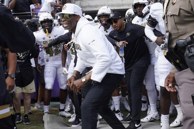 Colorado head coach Deion Sanders runs o<em></em>nto the field with his team before Saturday’s game against TCU in Fort Worth, Texas. (LM Otero / ASSOCIATED PRESS)