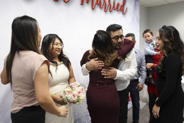 Angelica Rodriguez and Alfo<em></em>nzo Arroyo are co<em></em>ngratulated by Arroyo’s cousins Griselda Delgado, far left, Sandra Delgado, center, and Yesenia Delgado after they got married at the Cook County clerk’s office on Tuesday morning.