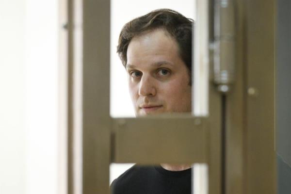 Wall Street Journal reporter Evan Gershkovich stands in a glass cage in a courtroom at the Moscow City Court in Moscow, Russia, Thursday, June 22, 2023. Gershkovich, a Wall Street Journal reporter detained on espio<em></em>nage charges in Russia, appeared in court Thursday to appeal his extended detention. (AP Photo/Dmitry Serebryakov)