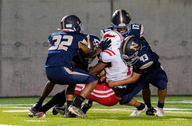 Mo<em></em>ntgomery wide receiver Izeyah Wright gets wrapped up by Napa’s defense moments after catching a long ball pass from quarterback Bobby McGovern on Friday, Sept. 8, 2022 in Napa. (Nicholas Vides / For The Press Democrat)