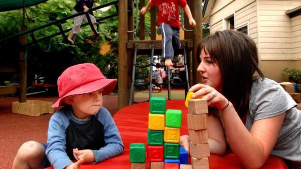 GENERIC PIC FOR ISSUES 9/9<em></em>
 <em></em>
 12/07/2008 LIBRARY: Childcare worker Catherine Butler playing with building blocks and talking with Jack Sandford, 4, while Magenta Ryderhoyte, 4, and Sam Gibbs, 4, climb on play equipment at the Blackfriers Childrens Centre in Chippendale, Sydney.