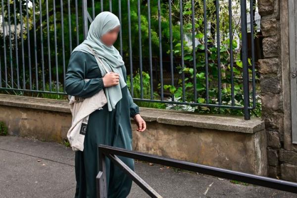 A photograph taken Mo<em></em>nday shows a woman wearing an abaya walking in the streets of Paris. France will ban students from wearing abayas in state-run schools, France's education minister said Sunday.