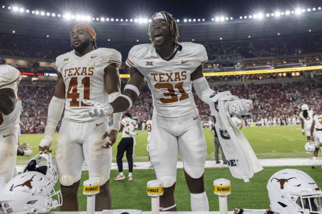 Texas edge defender Billy Walton III yells to Alabama fans to 'beat the traffic' during the final seco<em></em>nds of the second half Saturday, Sept. 9, 2023, in Tuscaloosa, Ala. Texas upset Alabama 34-24. Also in the photo is Texas linebacker Jaylan Ford (41). (AP Photo/Vasha Hunt)