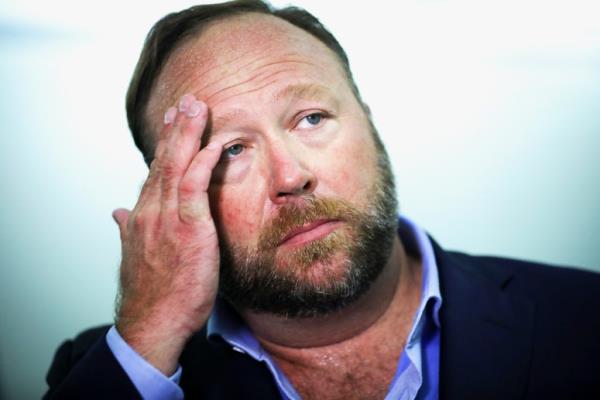 Alex Jo<em></em>nes of InfoWars wiping sweat from his brow.