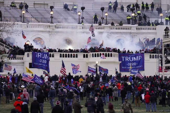 FILE - Violent rioters loyal to President Do<em></em>nald Trump storm the Capitol in Washington on Jan. 6, 2021.  (AP Photo/John Minchillo, File)