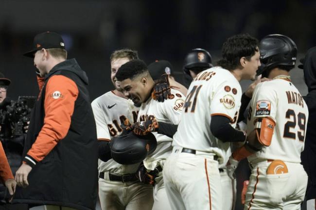 San Francisco Giants' LaMo<em></em>nte Wade Jr., holding helmet, celebrates with teammates after hitting the game-winning RBI single against the Cleveland Guardians during the 10th inning of a ba<em></em>seball game Monday, Sept. 11, 2023, in San Francisco. (AP Photo/Godofredo A. Vásquez)