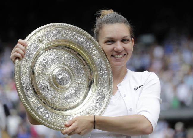 FILE - Romania's Simona Halep holds the trophy after defeating Serena Williams in the women's singles final of the Wimbledon Tennis Champio<em></em>nships in London, July 13, 2019. Two-time Grand Slam champion Simona Halep has been suspended from professio<em></em>nal tennis for four years for alleged doping violations, the Internatio<em></em>nal Tennis Integrity Agency said Tuesday, Sept. 12, 2023. (AP Photo/Ben Curtis, File)