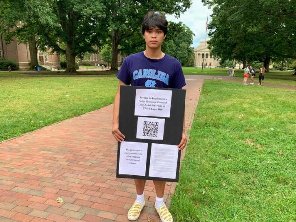 Micah Baldonado, a biomedical engineering student from Charlotte, N.C., holds his petition for improvements to the UNC-Chapel Hill active shooter respo<em></em>nse protocol on campus, Wednesday, Aug. 30, 2023, days after a shooting at the university.