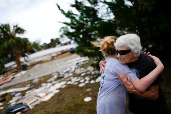 Tina Brotherton, 88, gets a hug from 9-year-old neighbor Lainey Hamel<em></em>ink, as she returns to site of her business, Tina's Dockside Inn, which was completely destroyed in Hurricane Idalia, as was Brotherton's nearby home, in Horseshoe Beach, Fla., on Sept. 1, 2023, two days after the storm's passage.