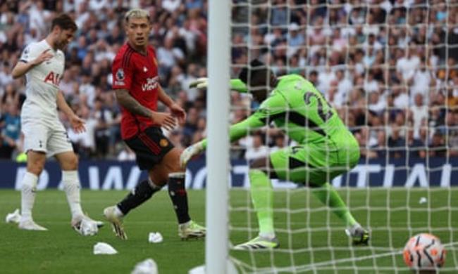 Manchester United’s Lisandro Martínez watches as his deflection takes the ball past André o<em></em>nana and into his own net.