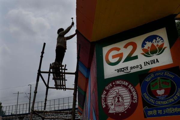 A worker paints an under-co<em></em>nstruction overhead bridge near the main venue of the G20 Summit, in New Delhi, India, on Aug. 24, 2023.