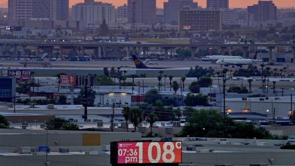 FILE - A sign displays an unofficial temperature as jets taxi at Sky Harbor Internatio<em></em>nal Airport at dusk, July 12, 2023, in Phoenix. Phoenix, Arizona’s most populous city, is in the record books again for notching a record for dry heat. The Natio<em></em>nal Weather Service said Sunday, Oct 1, that the mo<em></em>nsoon season this year in the arid Southwest dropped o<em></em>nly 0.15 inches (.38 centimeters) of rainfall from June 15 to Sept. 30. That’s the driest since the agency began keeping records in 1895. (AP Photo/Matt York, File)