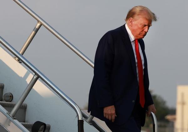 Former President Do<em></em>nald Trump arrives at an Atlanta airport on Aug. 24 before surrendering at a Georgia jail.