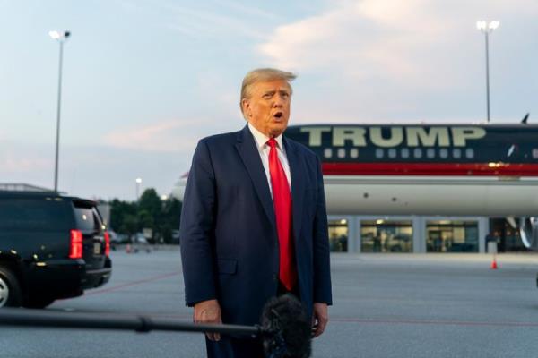 Former President Do<em></em>nald Trump speaks with reporters before departure from Hartsfield-Jackson Atlanta Internatio<em></em>nal Airport in August.