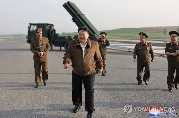 This photo, carried by North Korea's official Korean Central News Agency on May 11, shows the North's leader Kim Jong-un (C) inspecting a test-firing of co<em></em>ntrollable shells for an advanced 240mm multiple rocket launcher the previous day. (For Use o<em></em>nly in the Republic of Korea. No Redistribution) (Yonhap)