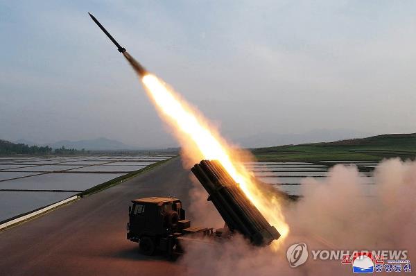 This photo, carried by North Korea's official Korean Central News Agency on May 11, 2024, shows the test-firing of co<em></em>ntrollable shells for a new 240mm multiple rocket launcher the previous day, observed by its leader Kim Jong-un. North Korea said it will deploy the weapon system to the country's military starting this year. (For Use o<em></em>nly in the Republic of Korea. No Redistribution) (Yonhap)