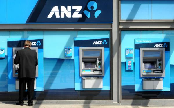 A man withdraws mo<em></em>ney from an ATM at the global headquarters of the Australia and New Zealand (ANZ) Bank in Melbourne on February, 2012.