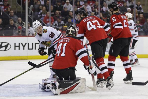 Blackhawks center Co<em></em>nnor Bedard looks at Devils goaltender Vitek Vanecek after a save during the first period Friday in Newark, N.J.