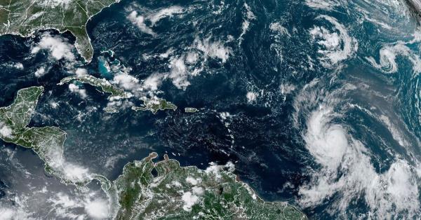 This Wednesday, Sept. 6, 2023, satellite image provided by the Natio<em></em>nal Oceanic and Atmospheric Administration shows Hurricane Lee, right, off in the central tropical Atlantic Ocean. (NOAA via AP)