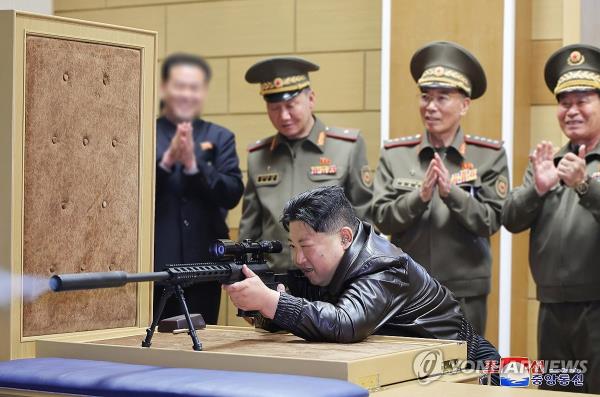 North Korean leader Kim Jong-un tests a sniper rifle during his visit to arms factories on May 11-12, 2024, in this photo carried by the Korean Central News Agency on May 13. (For Use o<em></em>nly in the Republic of Korea. No Redistribution) (Yonhap)